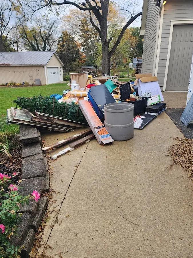 Dumpster being loaded with debris for Roofing Dumpster Rental in Fairwood